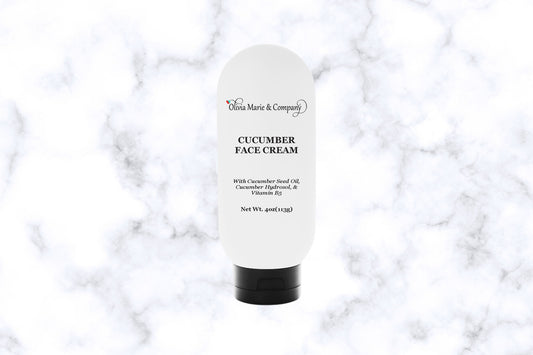 A white tube of Cucumber Face Cream with the brand name 'Olivia Marie & Company' on the label.