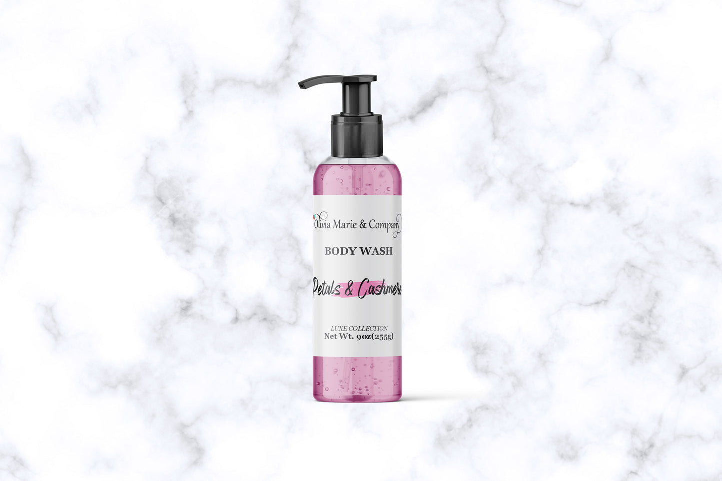 Pink bottle of body wash with pump on a marble background