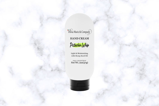 Hand cream bottle labeled 'Pistacho Whip' on a marble background