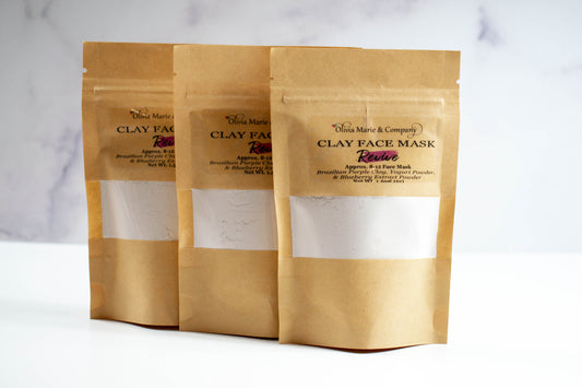Purple clay mask in brown bag with clear window.