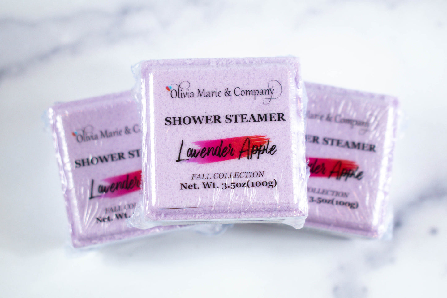 lavender apple shower steamer in a square shape colored purple.