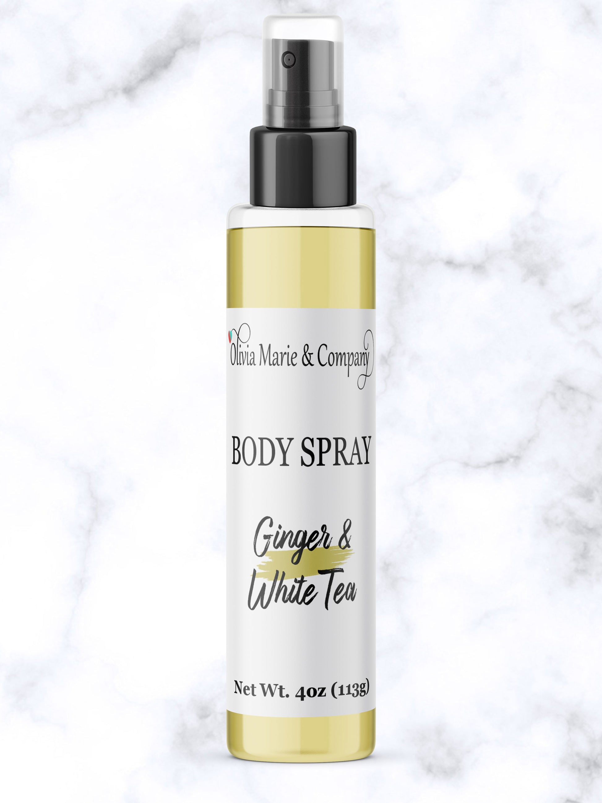 Body spray bottle labeled 'Ginger & White Tea' by Olivia Marie & Company on a marble background