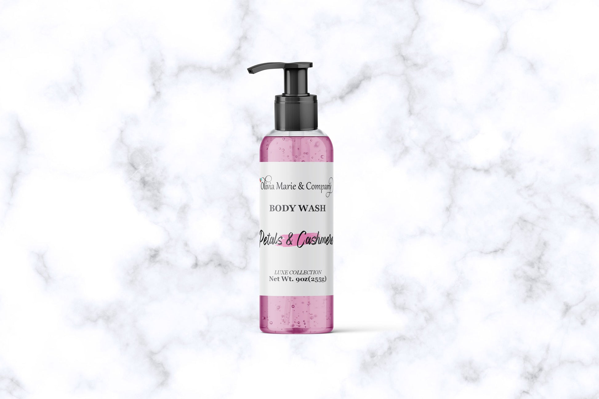 Pink bottle of body wash with pump on a marble background