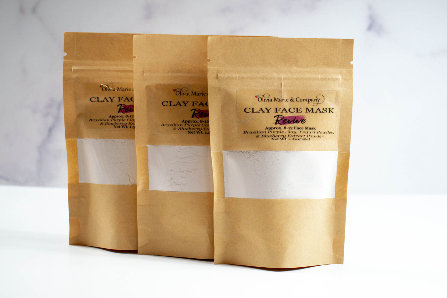 Purple clay mask in brown bag with clear window.