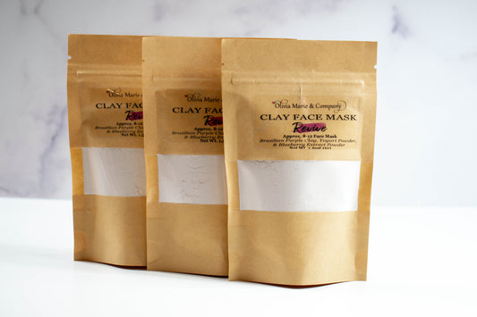 Purple clay mask in brown bag with clear window.