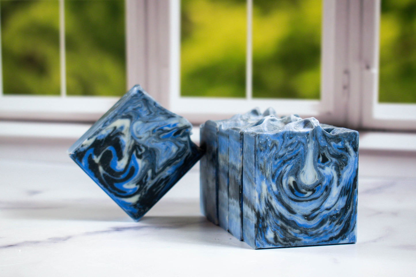A picture of water man soap with black, blue and white swirls