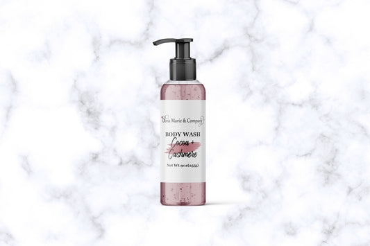 Cocoa Butter Cashmere body wash in a clear bottle with a rose pink color liquid.