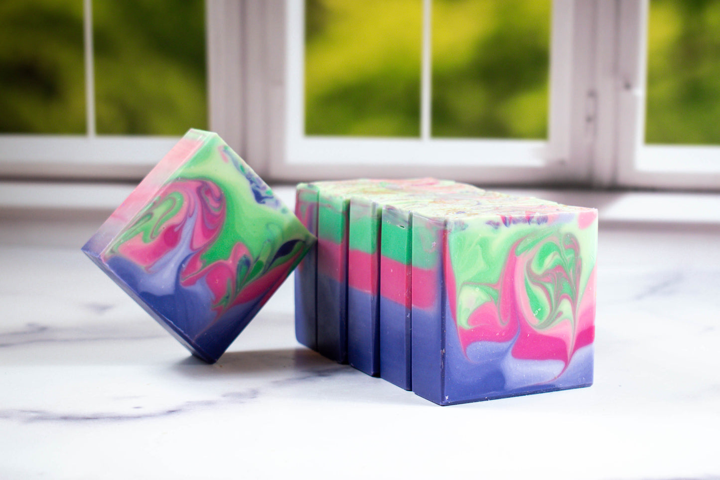 Enchanted soap with purple, pink, and green swirls.