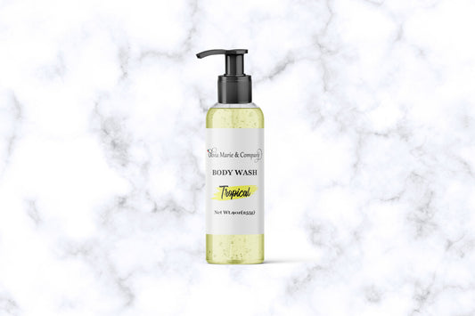 Tropical body wash in a clear bottle with a light yellow liquid.