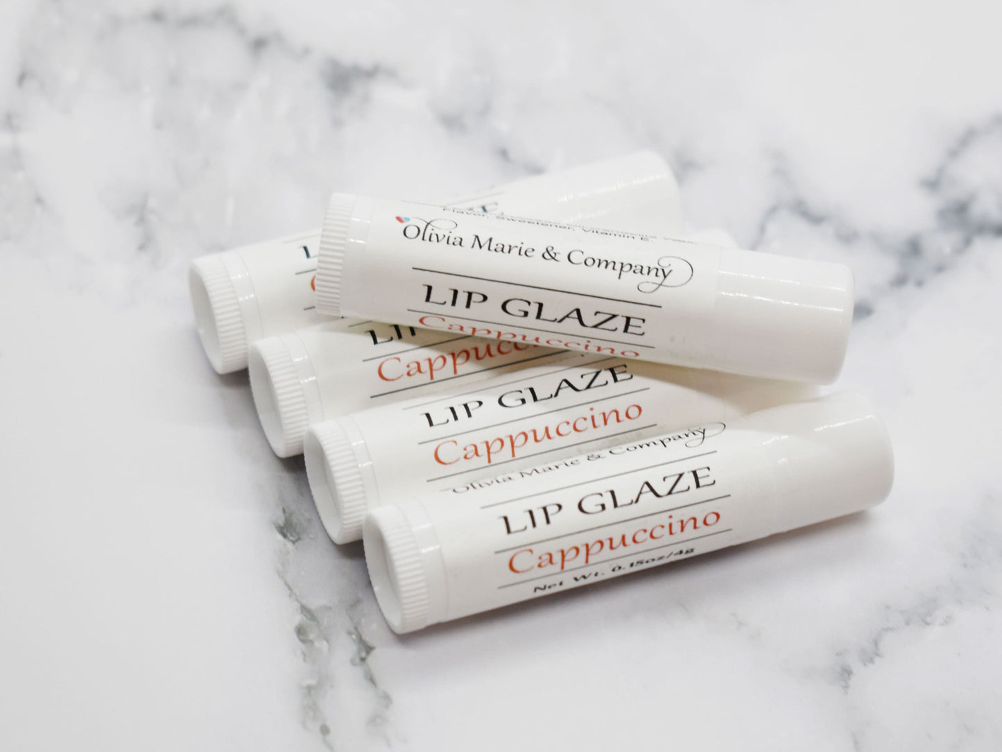 A stack of the lip balms in white tubes.